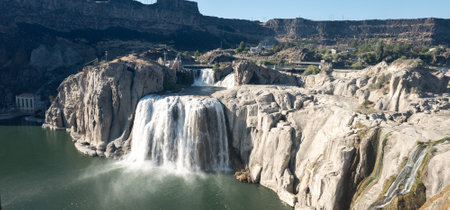 A waterfall is seen in the distance with a rocky shorelineの写真素材