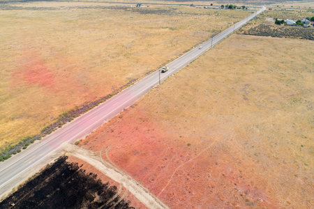 A road with a truck on it and a red line in the middleの写真素材