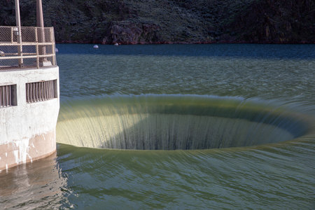 A large hole in the water with a boat in the backgroundの写真素材