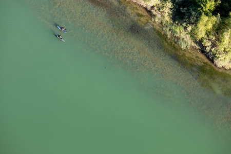 Two people are kayaking on a lakeの写真素材