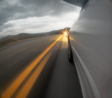 A blurry shot of a road with yellow lines
