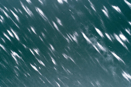 The image is of a body of water with a lot of white snow on it