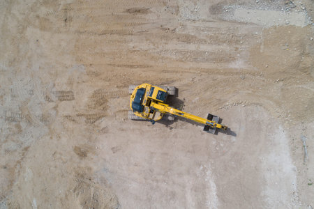 A yellow excavator is sitting in the dirt