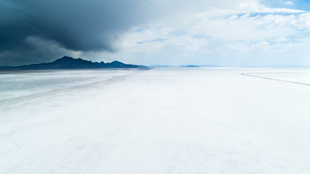 A desolate, snow-covered landscape with a stormy sky in the backgroundの写真素材