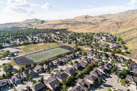 A residential area with a large field in the middleの写真素材