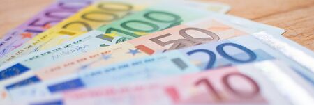 background with euro banknotes with different values and notepadの写真素材