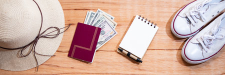 wooden background with money, passbook and passport