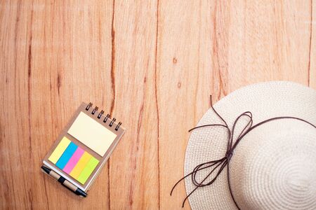 old wooden background with hat, and notepad,の写真素材