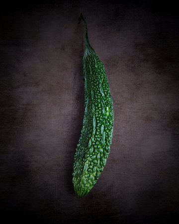 Bitter melon on dark grunge background with space for textの写真素材