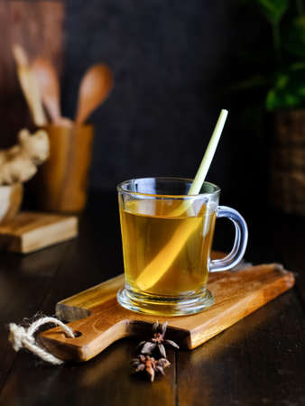 Empon-empon, Rimpang or Jamu, Indonesian traditional herbal drink, made from ginger, turmeric, and other herbs. Served in glass on wooden table, selective image and blurred background.の写真素材