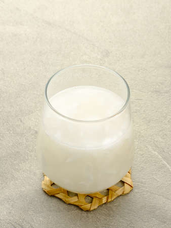 Es Kelapa Muda or young coconut ice, Indonesian popular drink, especially for breakfasting during ramadan month. Served in glass, copy space.の写真素材