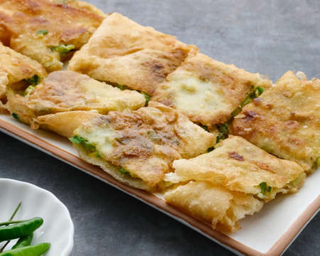 Martabak, Martabak Telor or Martabak Telur. Savory pan-fried pastry stuffed with egg, meat and spices. Martabak Telur is one of Indonesia street food. Served on plate, close up.の写真素材