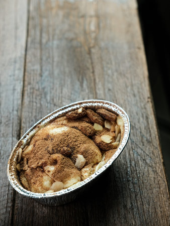 Klappertaart is one of indonesian traditional dessert, from Manado. Bread klappertaart with raisin and almond topping, dusted with cinnamon powder, Dutch influenced dessert.の写真素材