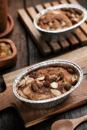 Klappertaart is one of indonesian traditional dessert, from Manado. Bread klappertaart with raisin and almond topping, dusted with cinnamon powder, Dutch influenced dessert.の写真素材