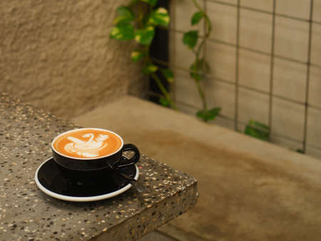A cup of hot latte coffee on the table for breakfastの写真素材