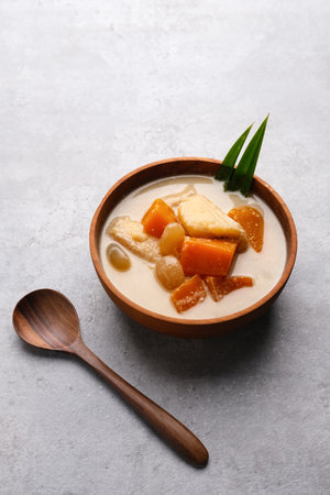 Kolak or Kolak Pisang is Indonesian dessert, very popular during Ramadhan, made from banana, kolang-kaling, sweet potato cooked with coconut milk, palm sugar and pandanus leaves. Selective focusの写真素材