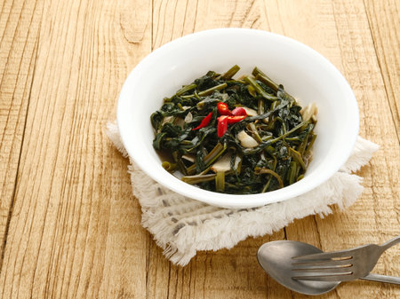 Tumis Kangkung, Ca Kangkung, is one of Indonesian food. Served on white bowl on grey background.の写真素材