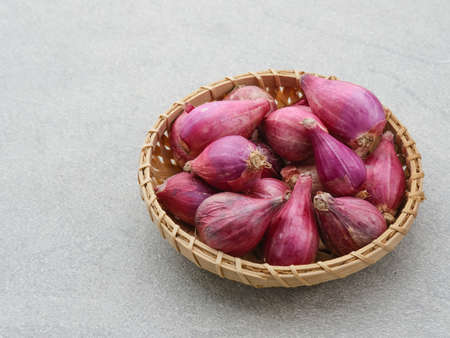 Shallots. Fresh purple shallots on wooden board. Shallots close up.の写真素材