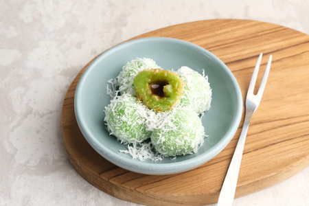 Klepon is Indonesian popular traditional snack, made from glutinous rice flour which is formed into small balls and filled with brown sugar. Finally covered with grated coconut.の写真素材