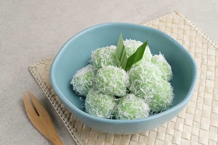 Klepon is Indonesian popular traditional snack, made from glutinous rice flour which is formed into small balls and filled with brown sugar. Finally covered with grated coconut.の写真素材