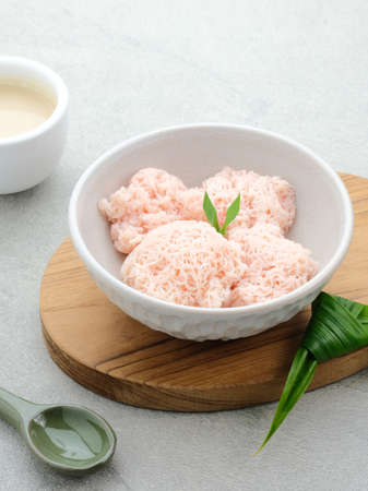 Kue Putu Mayang is traditional Indonesian snack of rice flour strands curled up into a ball, eaten with coconut milk and palm sugar.の写真素材