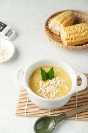 Bubur jagung manis, or sweet corn porridge, an indonesian dessert for ifthar. Sweet snack or dessert made from sweet corn, milk, coconut milk, and rice flour. Blurred background. Selective focus.の写真素材