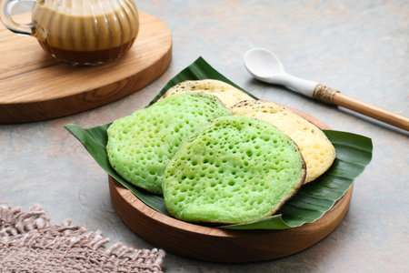 Serabi or Surabi,  Indonesian pancake made of flour, rice flour and coconut milk. Served with palm sugar sauce. Sweet and savory.の写真素材