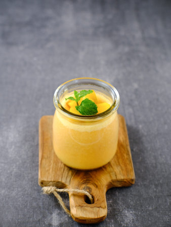 Mango pudding topped with mango chunks and mint leaf garnish. Served in a jar. Very fresh and...