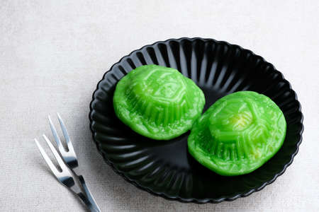 ANG KUE or Kue Ku, steamed Chinese pastry of glutinous rice flour with sweet mung bean paste filling. Sticky, chewy texture. Selective focus image, blurrred background.の写真素材