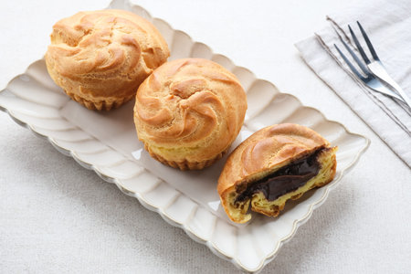 Chocolate Soes Cakes ( Sus Vla ), served in white plate, copy space.