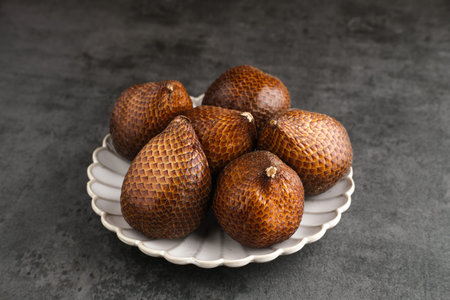 Salak or thorny palm or snake fruit (Salacca zalacca) is a species of palm tree. Selective focus...