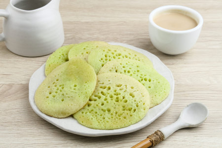 Serabi or Surabi,  Indonesian pancake made of flour, rice flour and coconut milk. Served with palm...