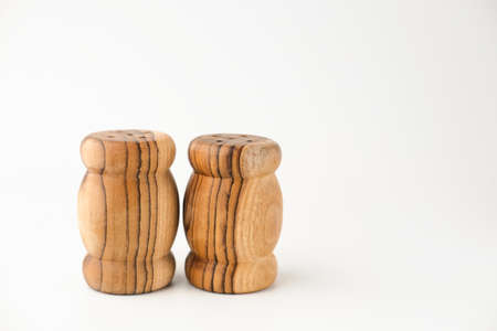 Wooden traditional salt and pepper shakers on white background, selective focus, copy space.の写真素材