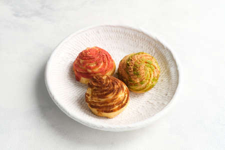 Choux pastry contains only butter, water, flour, and eggs. Choux pastries are sometimes filled with cream after baking to make cream puffs. Selective focus image,の写真素材