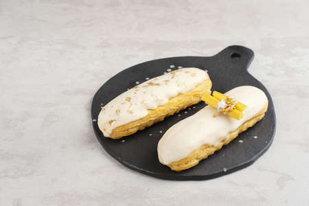 Traditional French dessert. Sweet and colorful eclairs with chocolate glaze.の写真素材