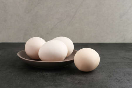Fresh chicken eggs ( Telur Ayam Kampung ). White eggs with copy space. Top view.の写真素材