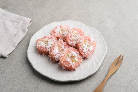 Kue Kacamata or Mata Roda is a traditional javanese snack. Bananas wrapped in rice flour dough,...
