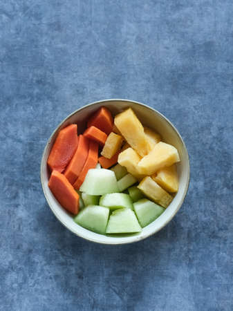 Mixed fruit salad in the bowl, consist of melon, mango and papaya. Copy space.の写真素材
