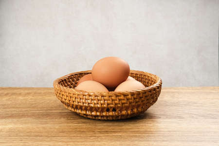 Raw organic farm eggs. Served in rattan basket with copy space. Selective focus image.の写真素材