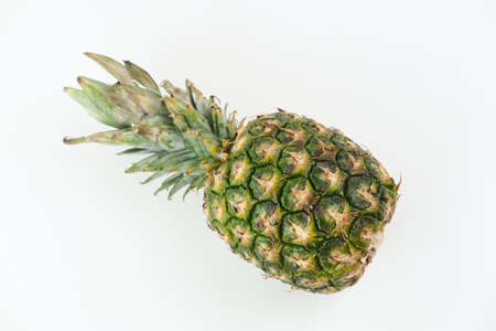 Fresh pineapple (Nanas honi) isolated on white table background. Copy space, selected focus.の写真素材