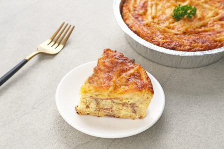 Baked Macaroni Schotel in an aluminium foil cup. Selective focus.