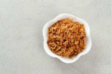 Indonesian crispy deep fried shallots or onion flakes (bawang goreng. Copy space, selected focus...