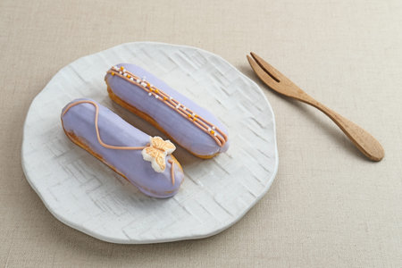 Traditional French dessert. Sweet and colorful eclairs with chocolate glaze.