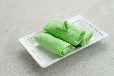 Kue dadar gulung (Sweet coconut pancake), Indonesian dessert made from flour with grated coconut mixed palm sugar. Selected focus.の写真素材