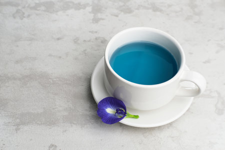 Teh Telang, Butterfly flower tea or Blue Tea is herbal tea made from the herb or infusion of the Clitoria ternatea plant flower. Selective focus.の写真素材