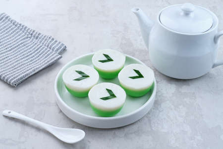 Kue Nona Manis, traditional Indonesian cake made from wheat flour, rice flour, sugar, salt, coconut milk, and pandan leaves, then steamed. Selected focus.の写真素材