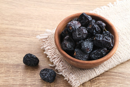 Kurma Ajwa, Ajwa Dates, served in wooden bowl. Kurma Ajwa is one of the special fruit of Arabic.