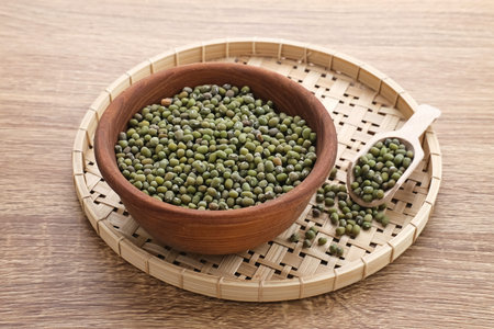 Group of green mung beans served on wooden bowl on wooden background.の写真素材