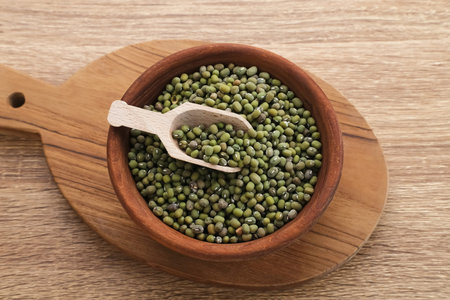 Group of green mung beans served on wooden bowl on wooden background.の写真素材
