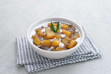 Bubur Ubi atau Jenang Telo is a dessert from Indonesia made of sweet potato, palm sugar and tapioca flour served with coconut milk.の写真素材